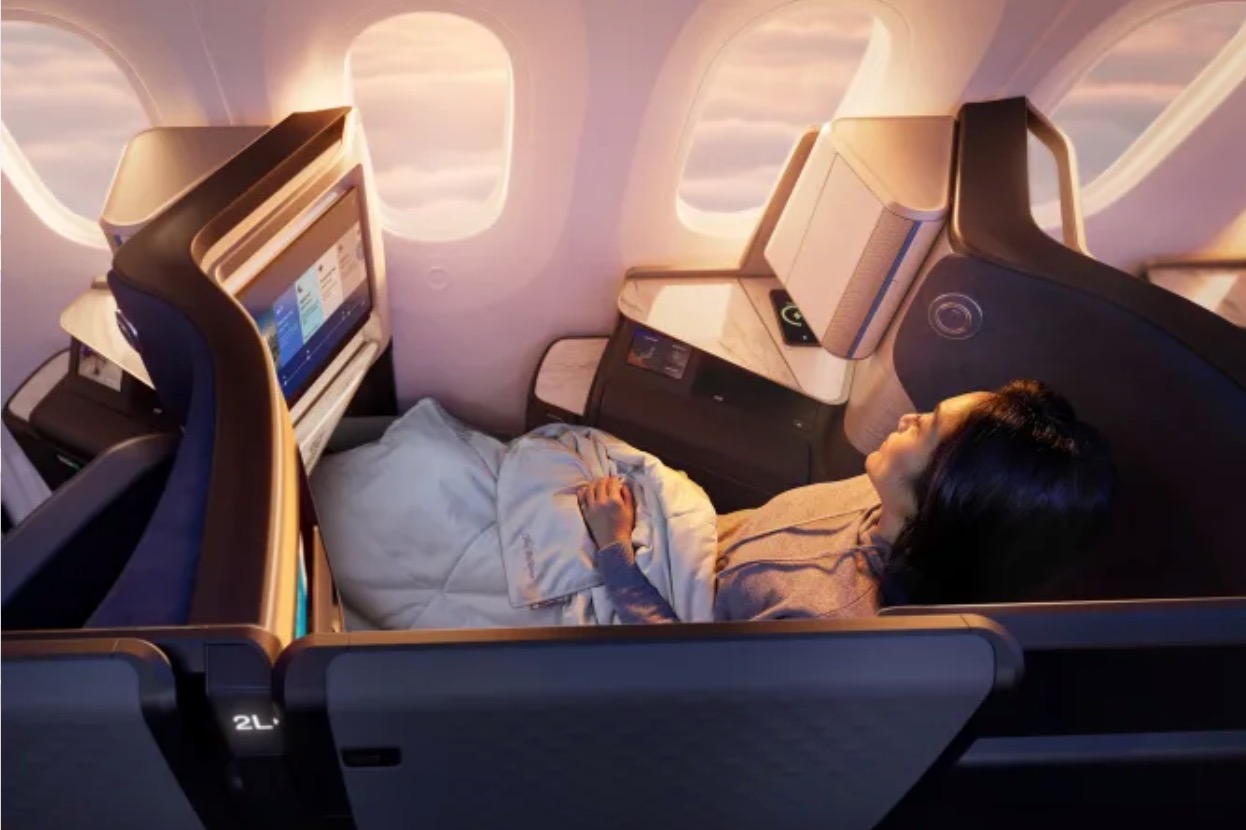 United Polaris Studio a woman sleeping in an airplane