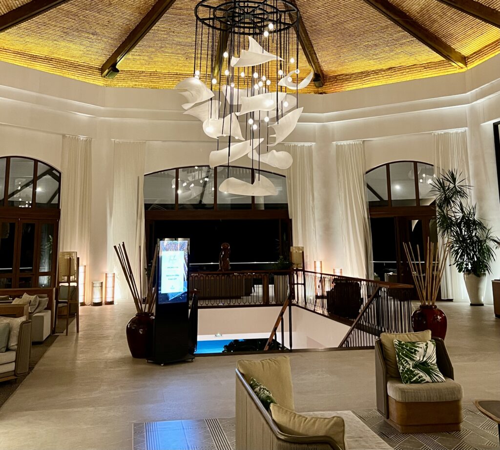 a room with a chandelier and a couch