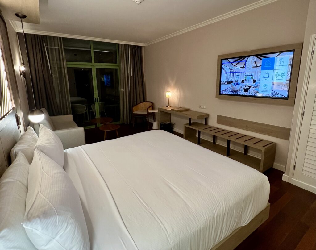 a bed with a television on the wall