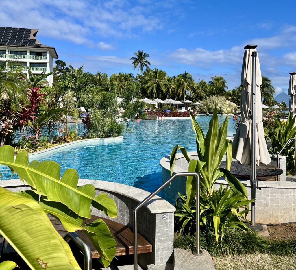 a pool with a bench and umbrella