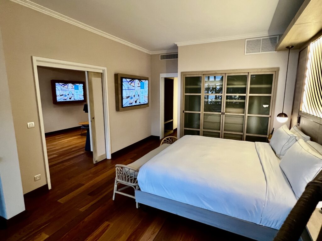 a bedroom with a bed and two televisions