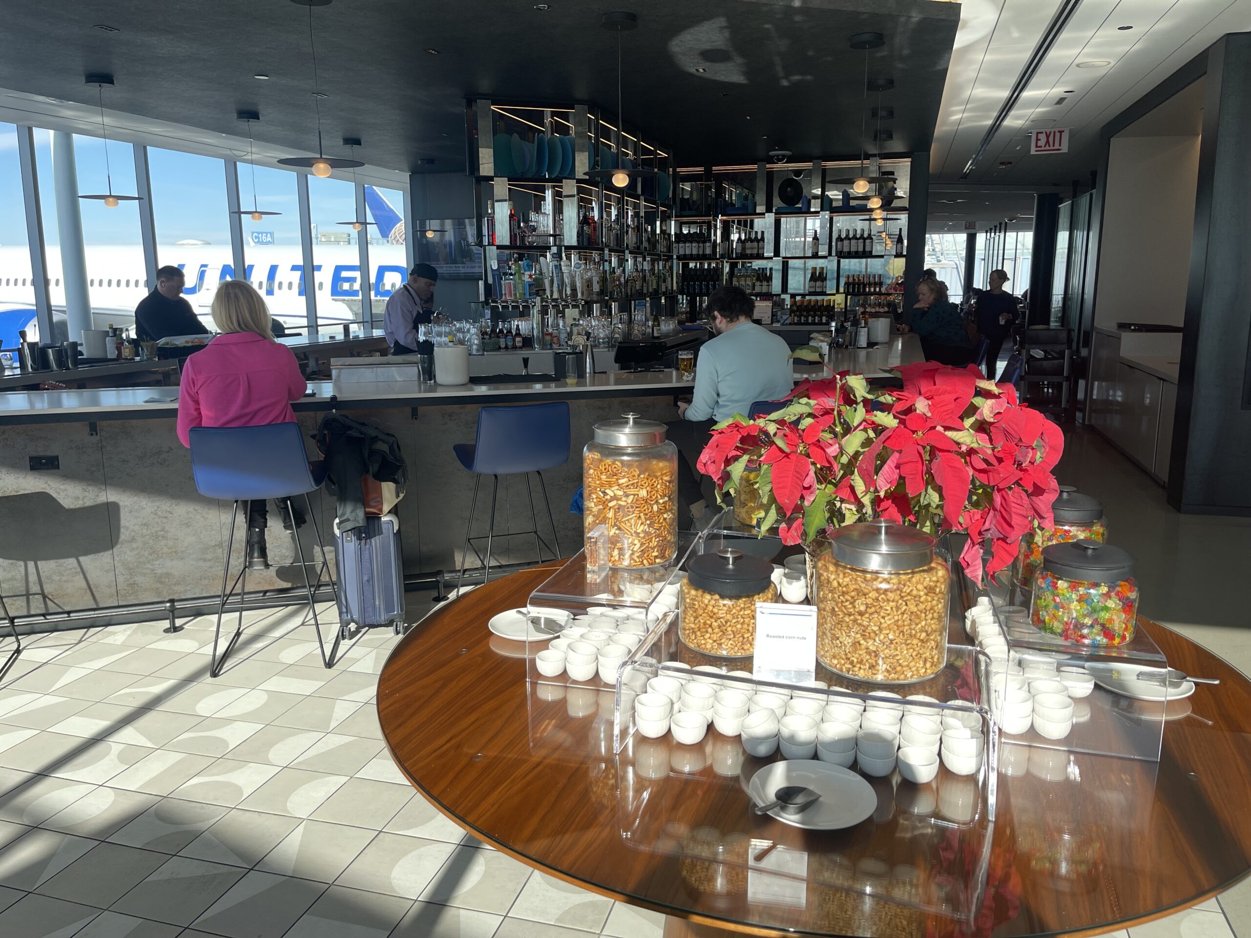 United Club Chicago ORD a group of people sitting at a counter in a restaurant