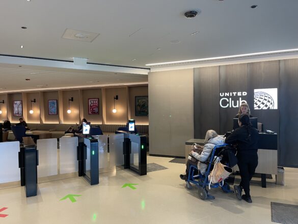 a group of people standing in front of a check-in counter