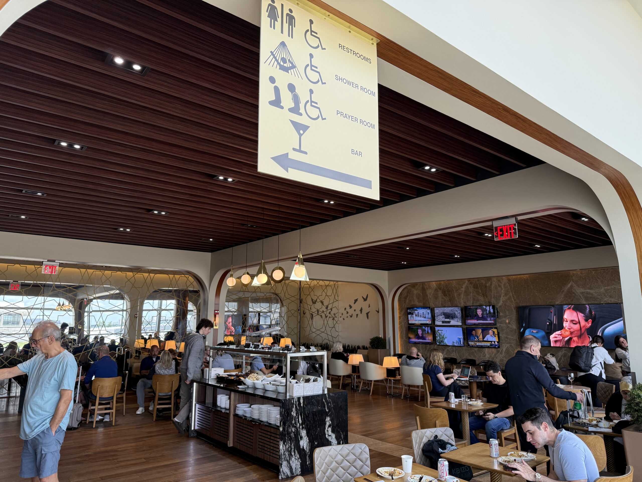 Turkish Airlines Lounge Washington a large room with tables and chairs and people sitting at tables