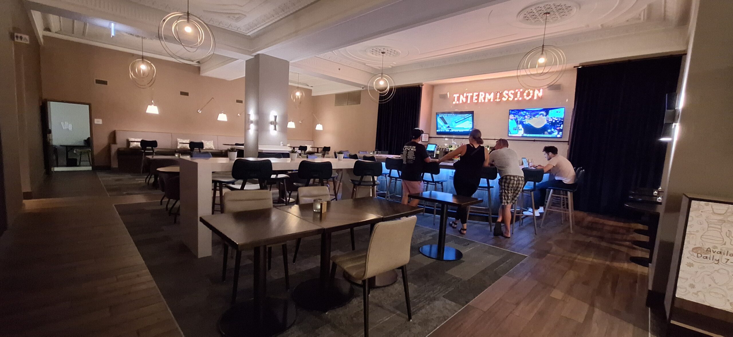 Cambria Hotel Chicago people in a room with tables and chairs