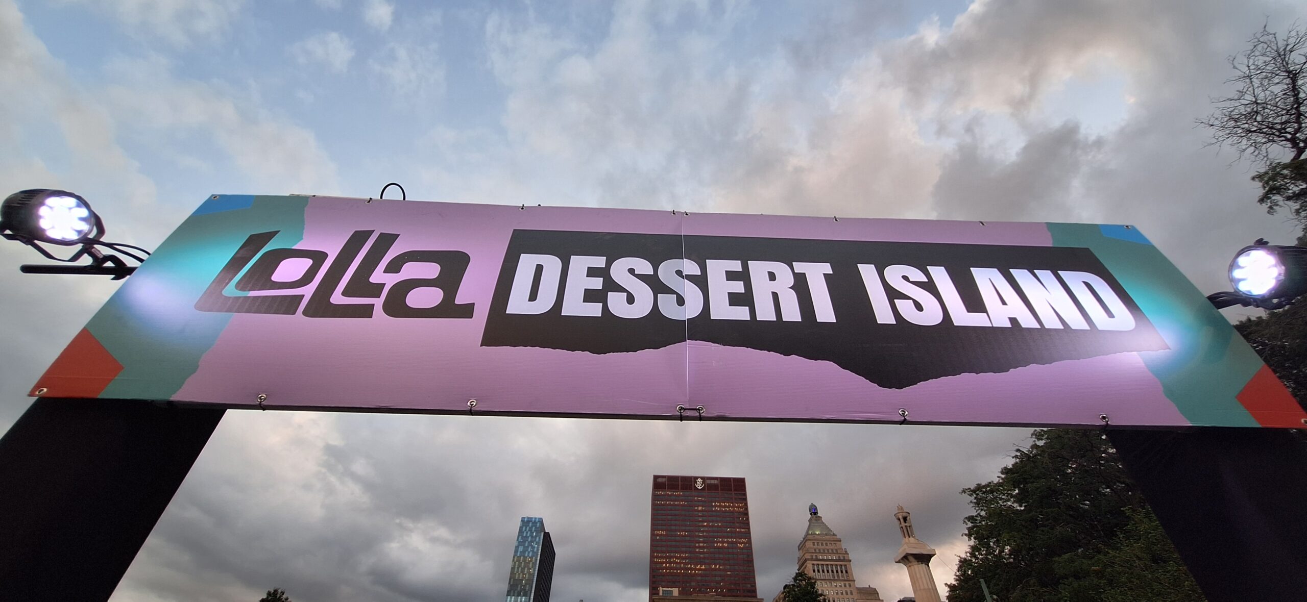 a sign with a city in the background