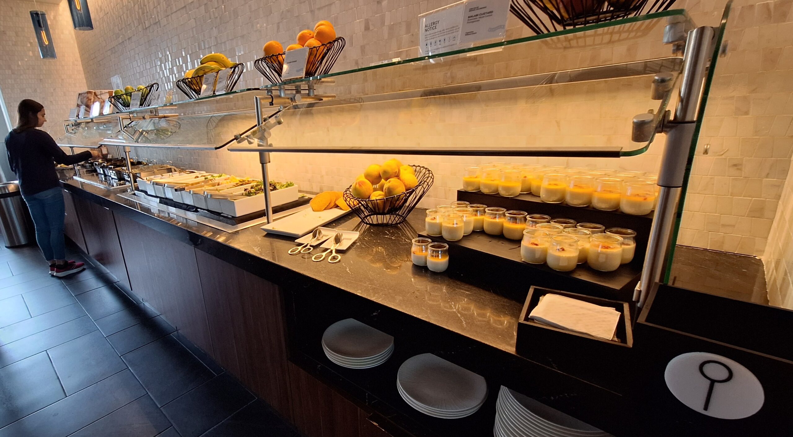 Centurion Lounge Philadelphia a buffet with fruit and desserts