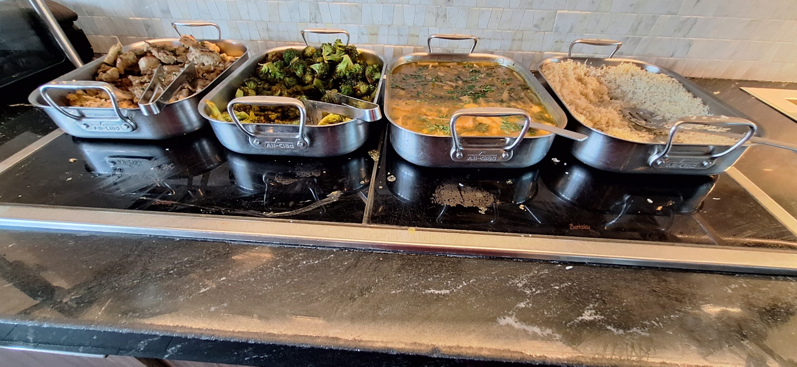 Centurion Lounge Philadelphia a row of metal pans with food in them