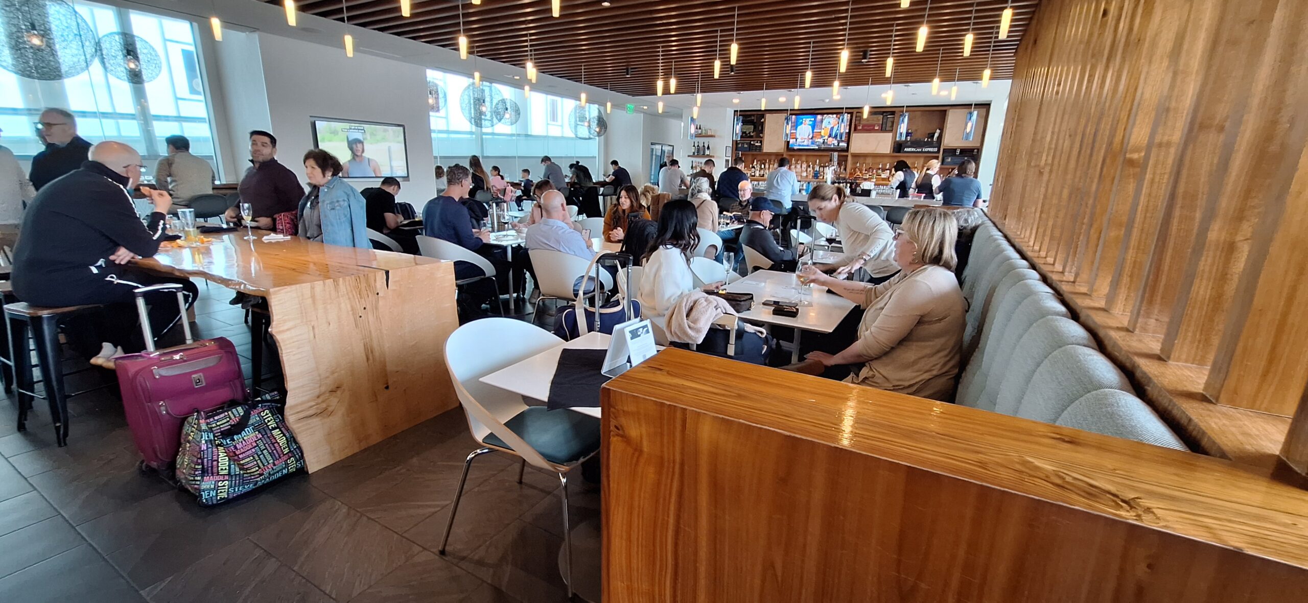Centurion Lounge Philadelphia a group of people sitting at tables in a restaurant