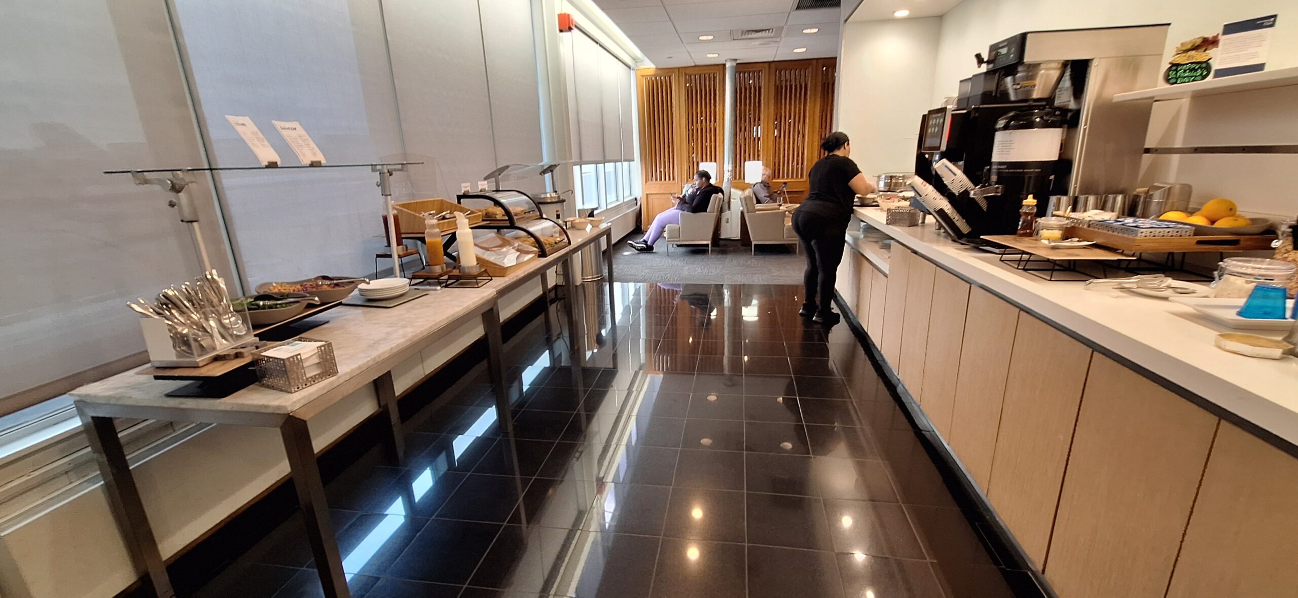 a woman standing in a room with a buffet