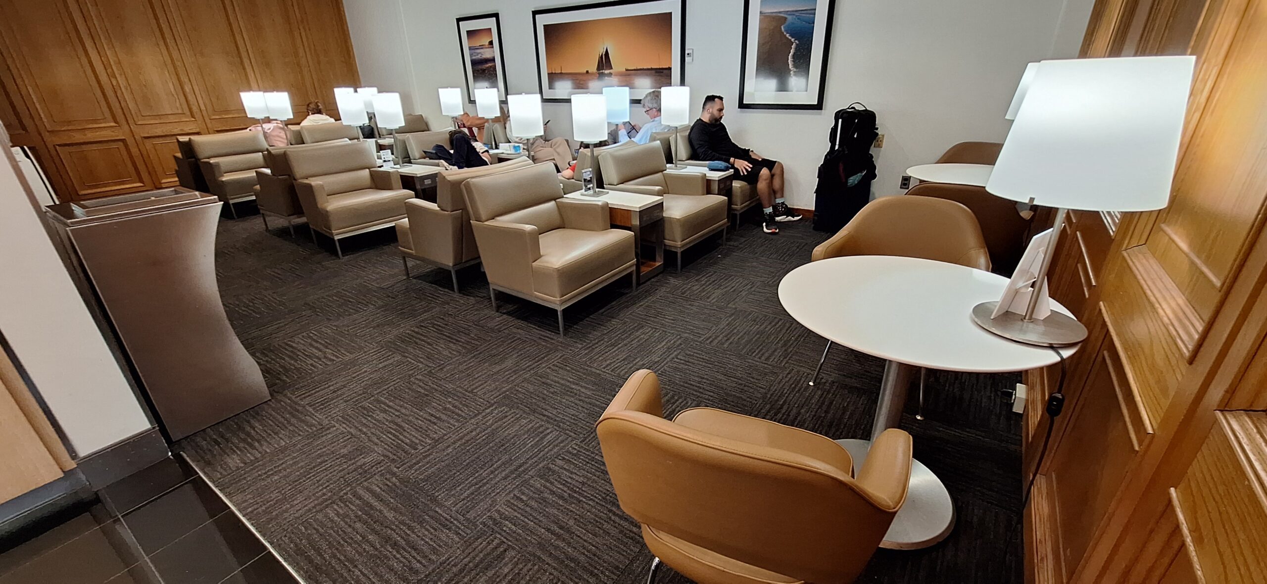 a room with chairs and tables and lamps