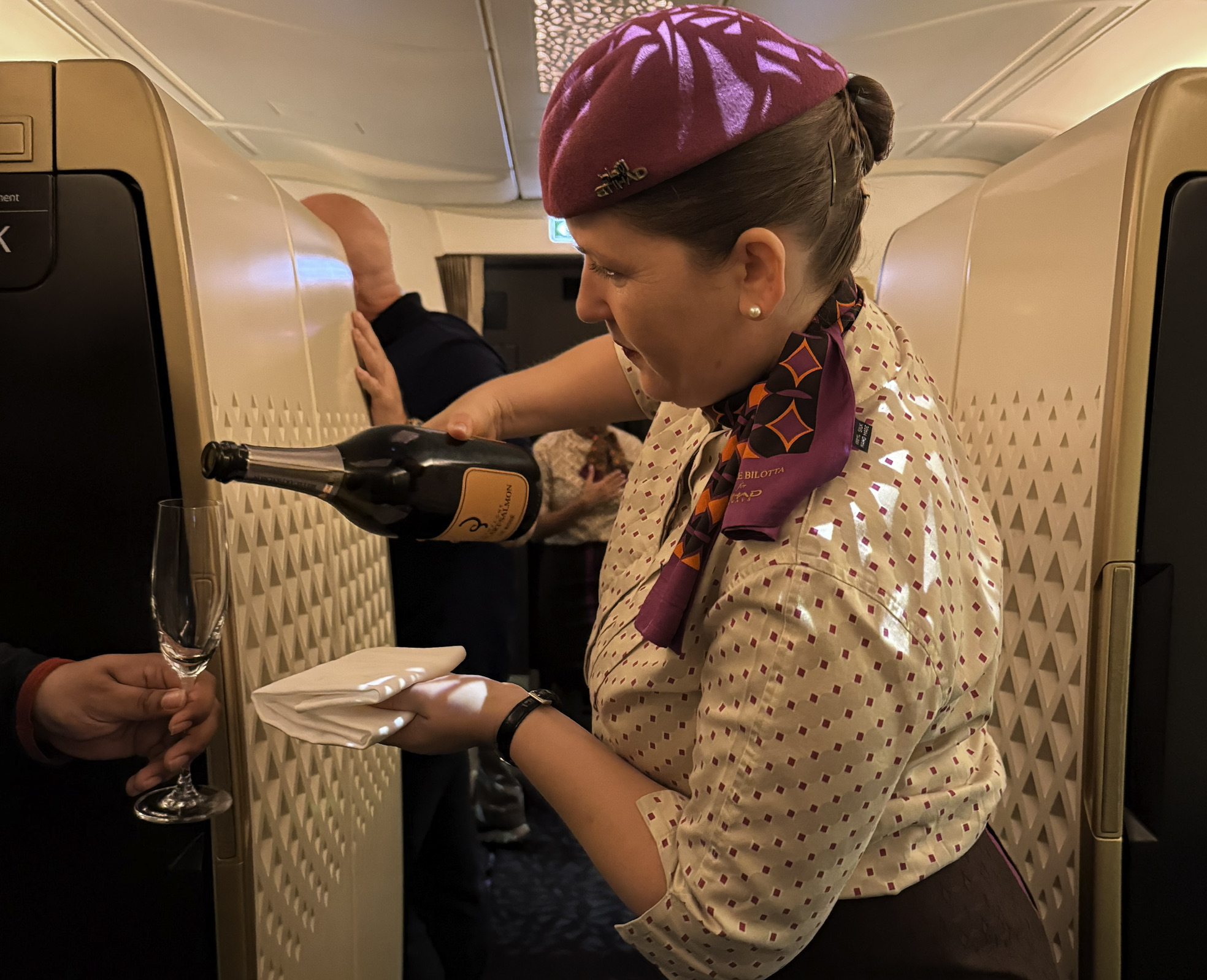 a woman pouring champagne into a glass