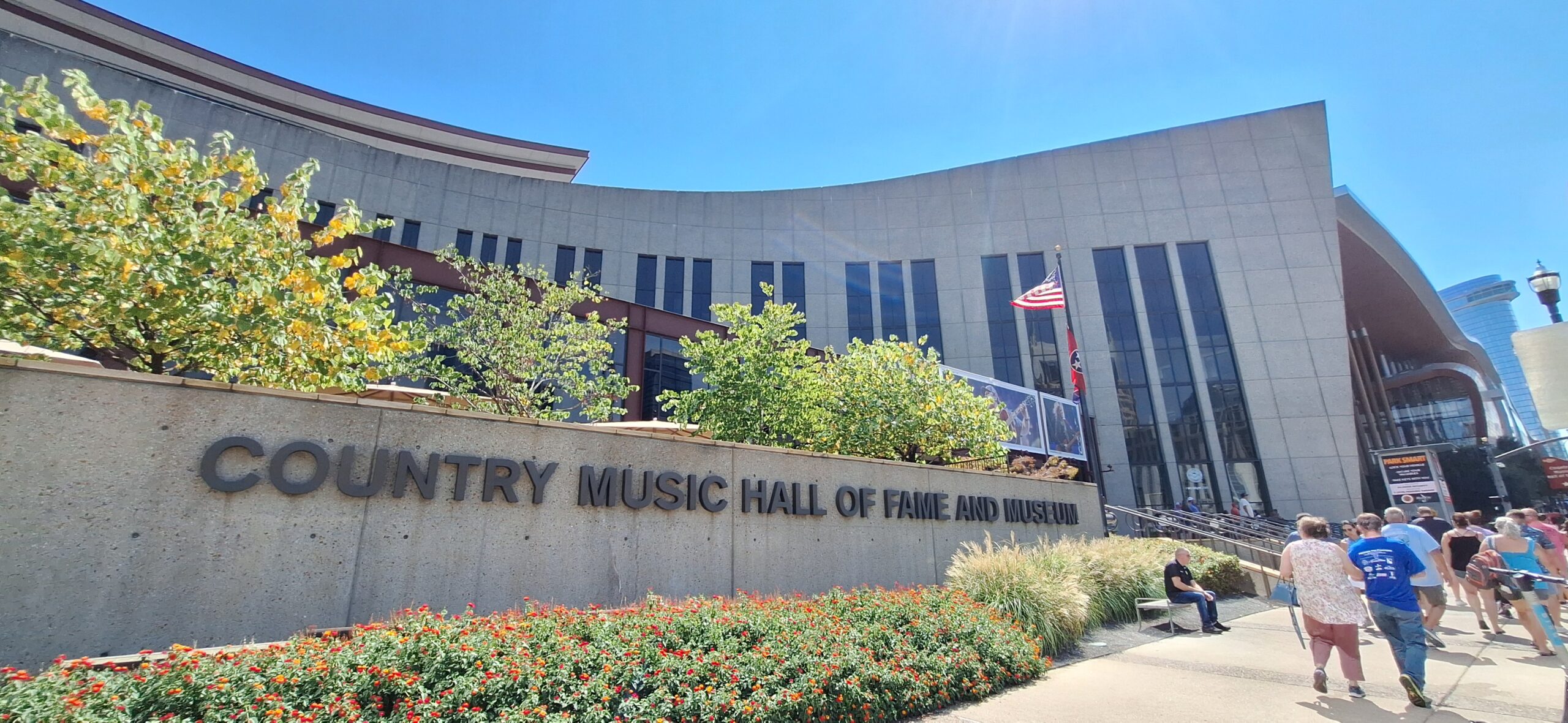Country Music Hall of Fame and Museum with a sign and flowers