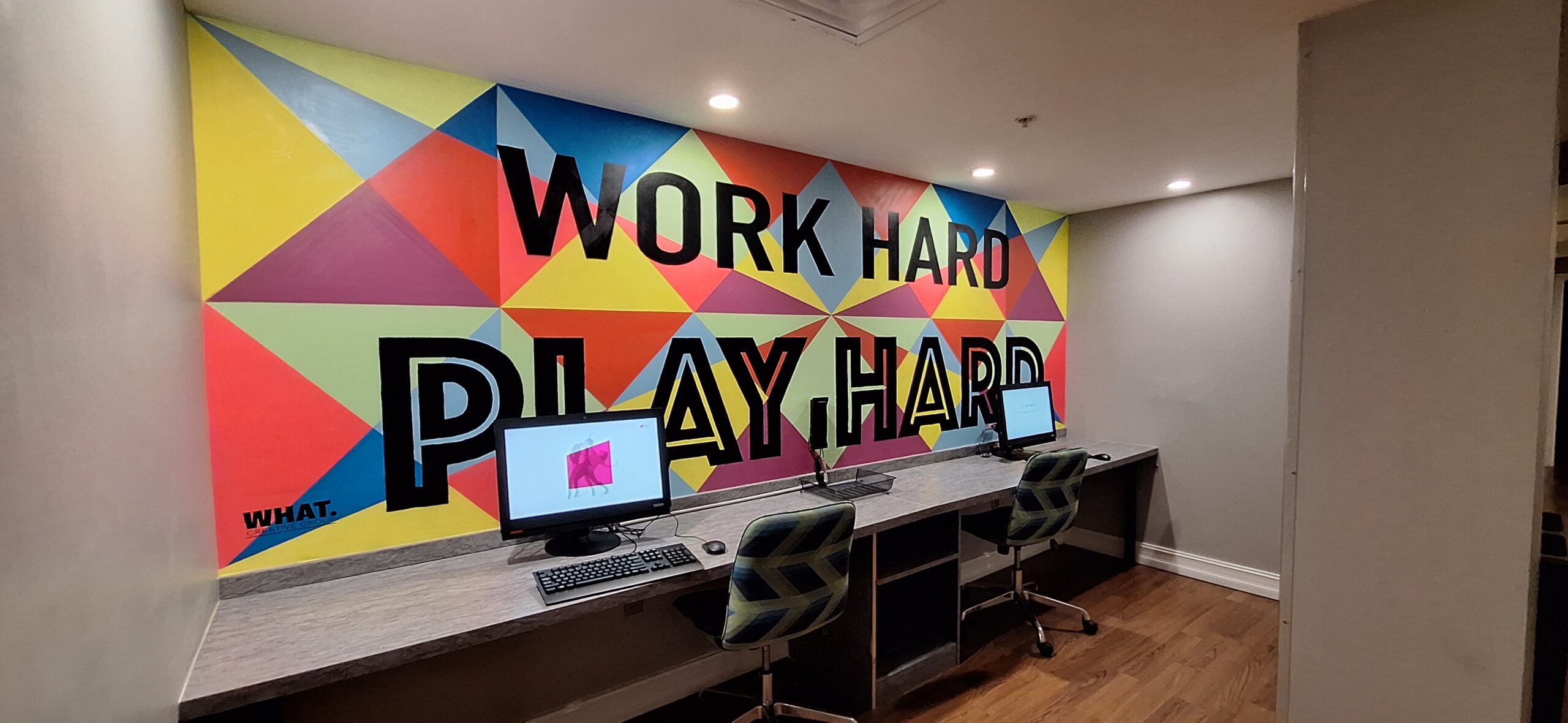 Marriott Aloft Nashville review a desk with computers and chairs in front of a colorful wall