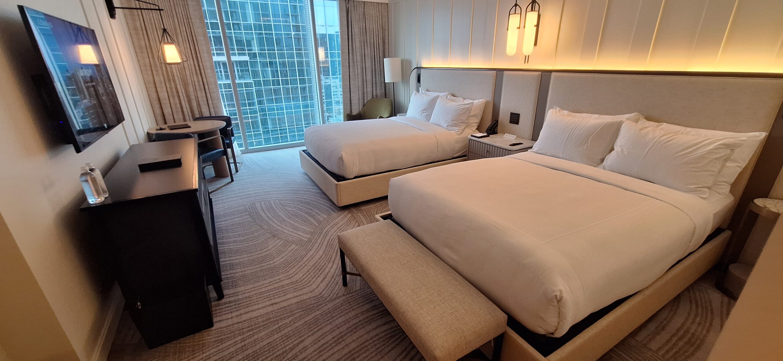 Conrad Nashville Review a room with two beds and a table