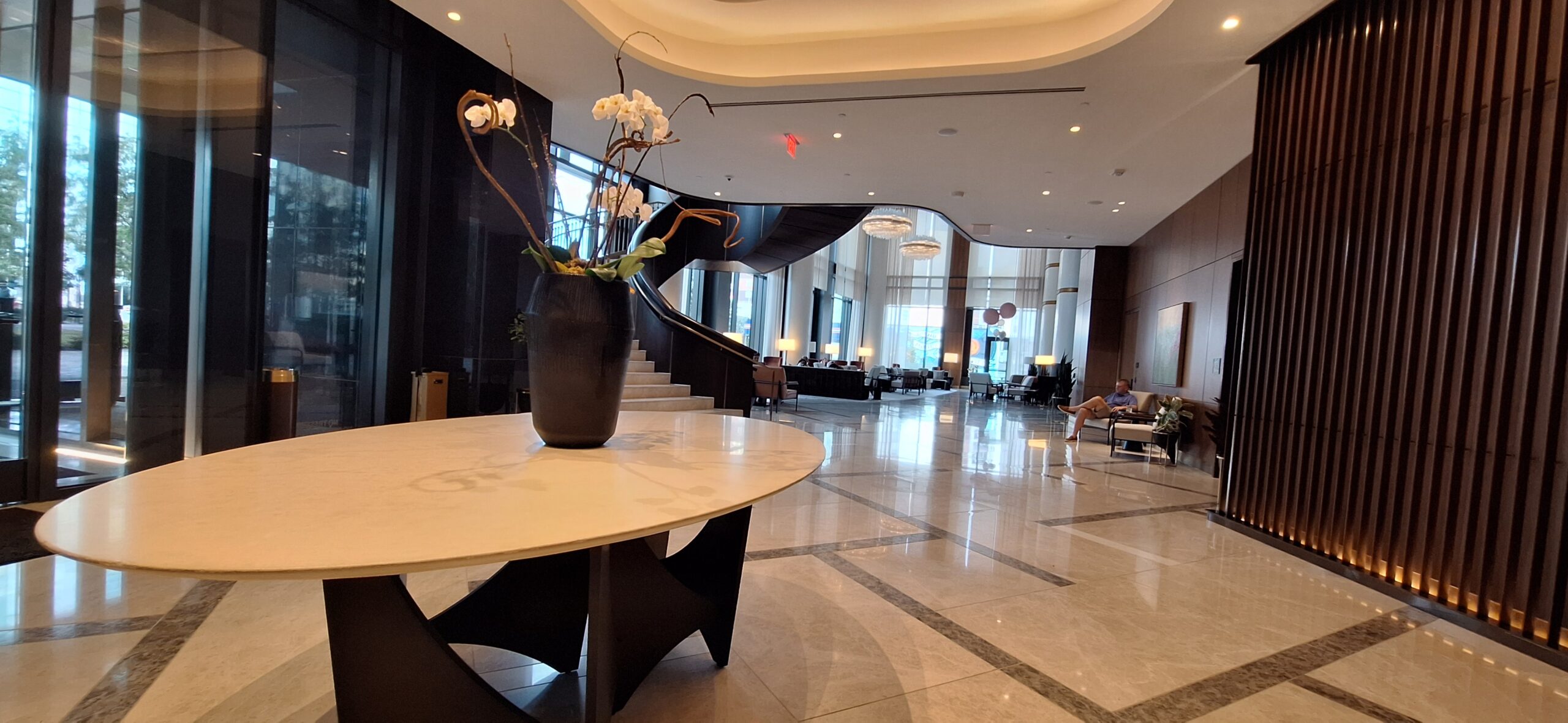 Conrad Nashville Review a large lobby with a vase of flowers