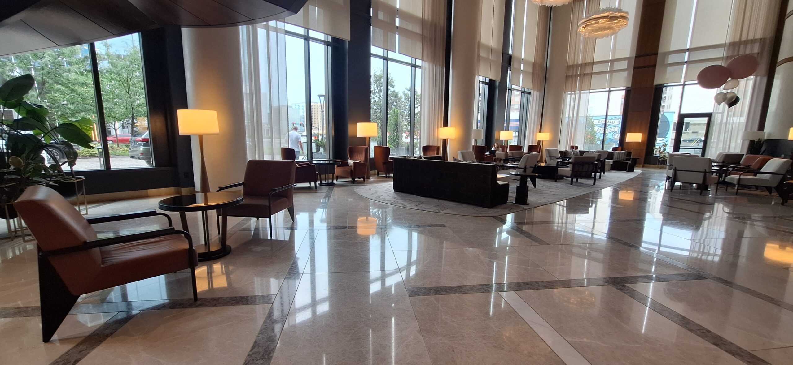 Conrad Nashville Review a large room with a large window and chairs
