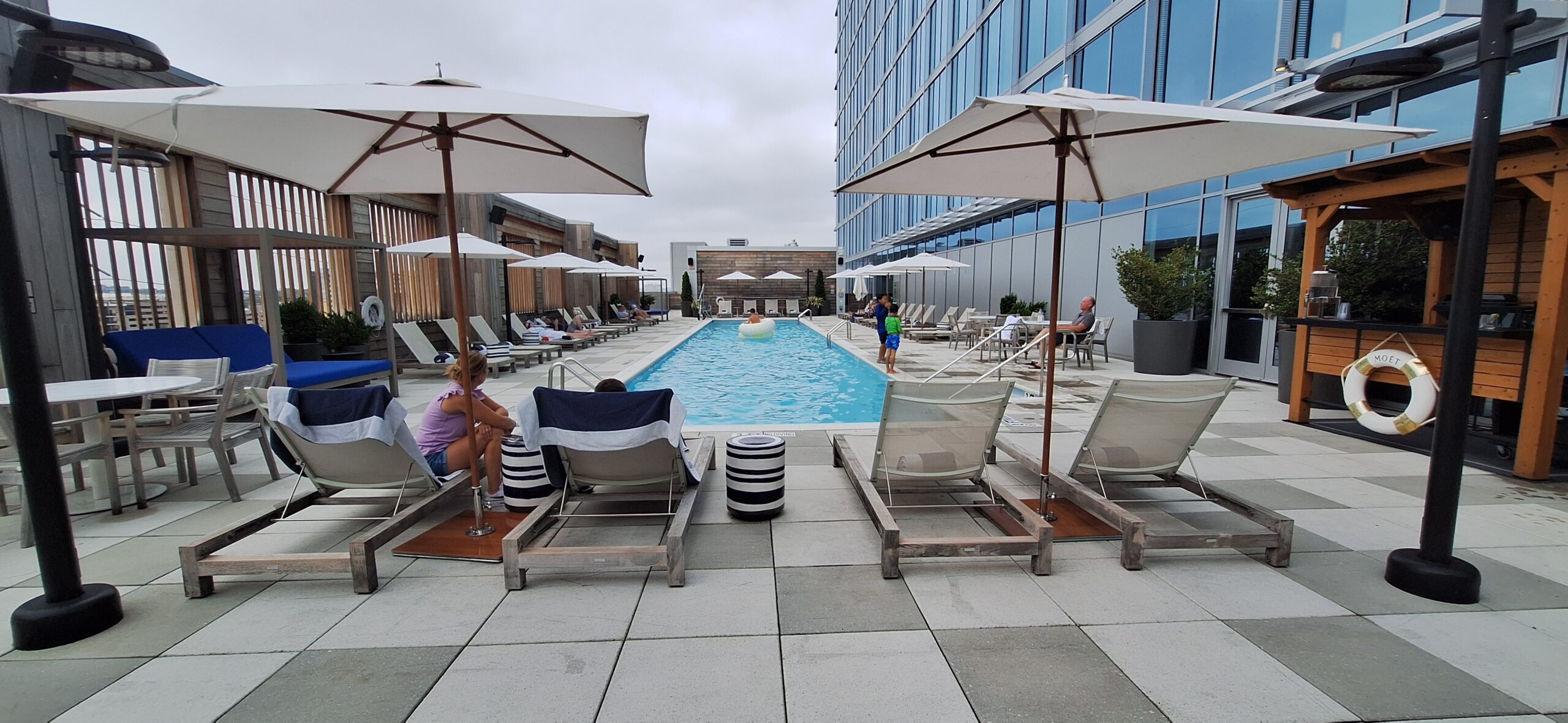 Conrad Nashville Review a pool with chairs and umbrellas