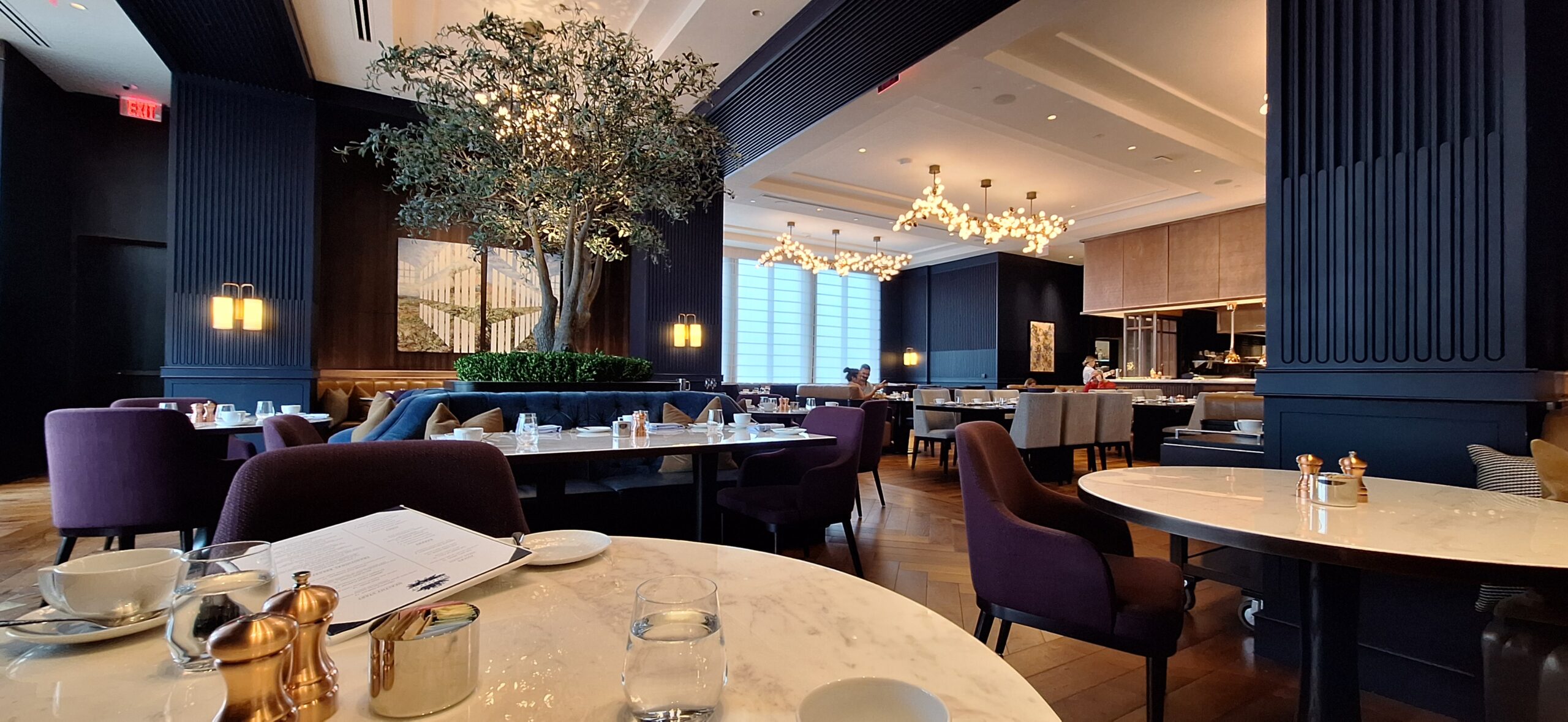 Conrad Nashville Review a room with tables and chairs