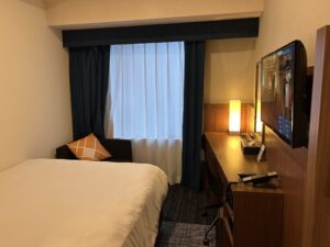 Four Points Flex Osaka a bed with a tv in a room