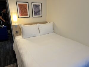 Four Points by Sheraton a bed with white sheets and pillows