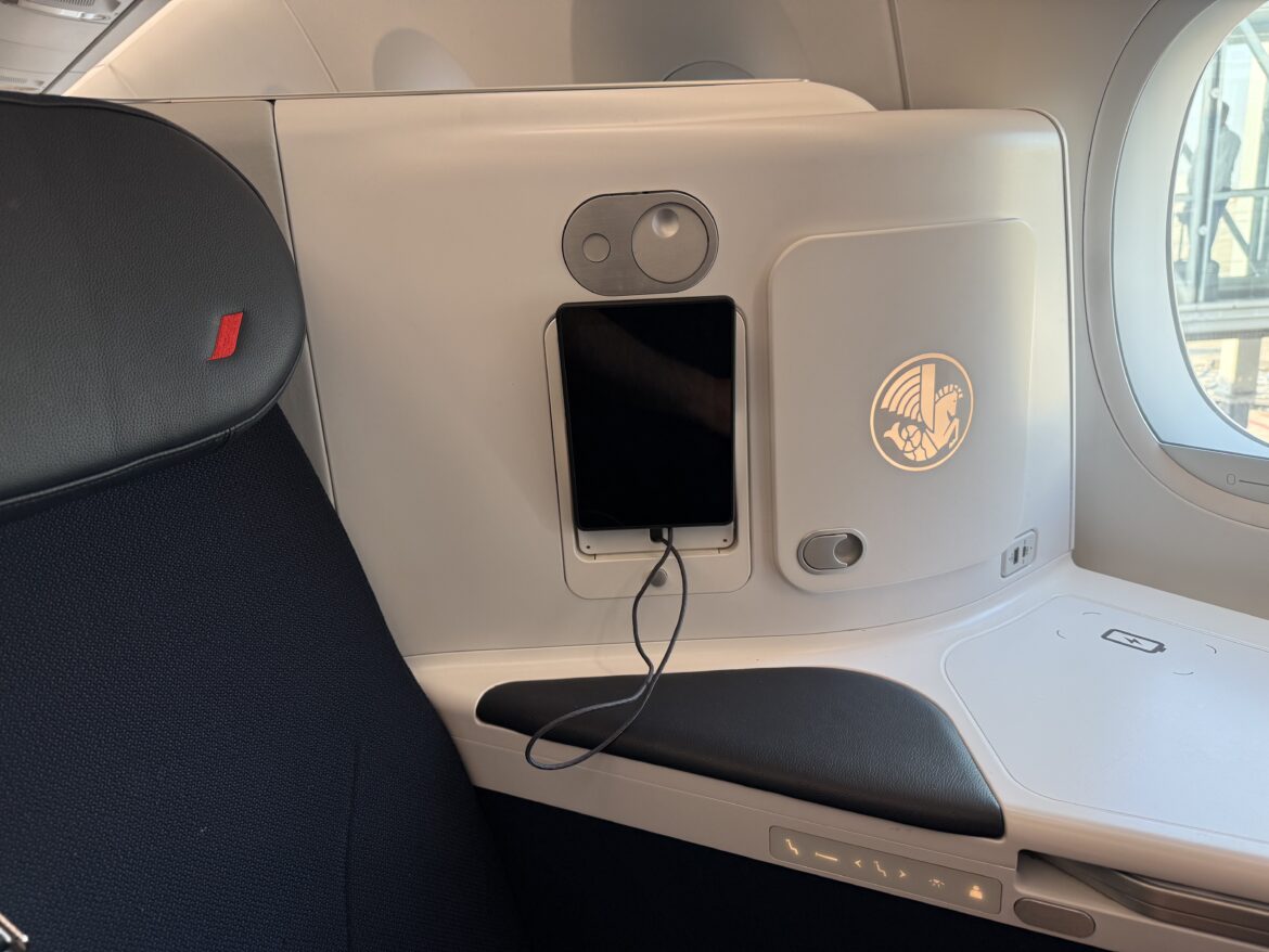 a phone charging on a seat