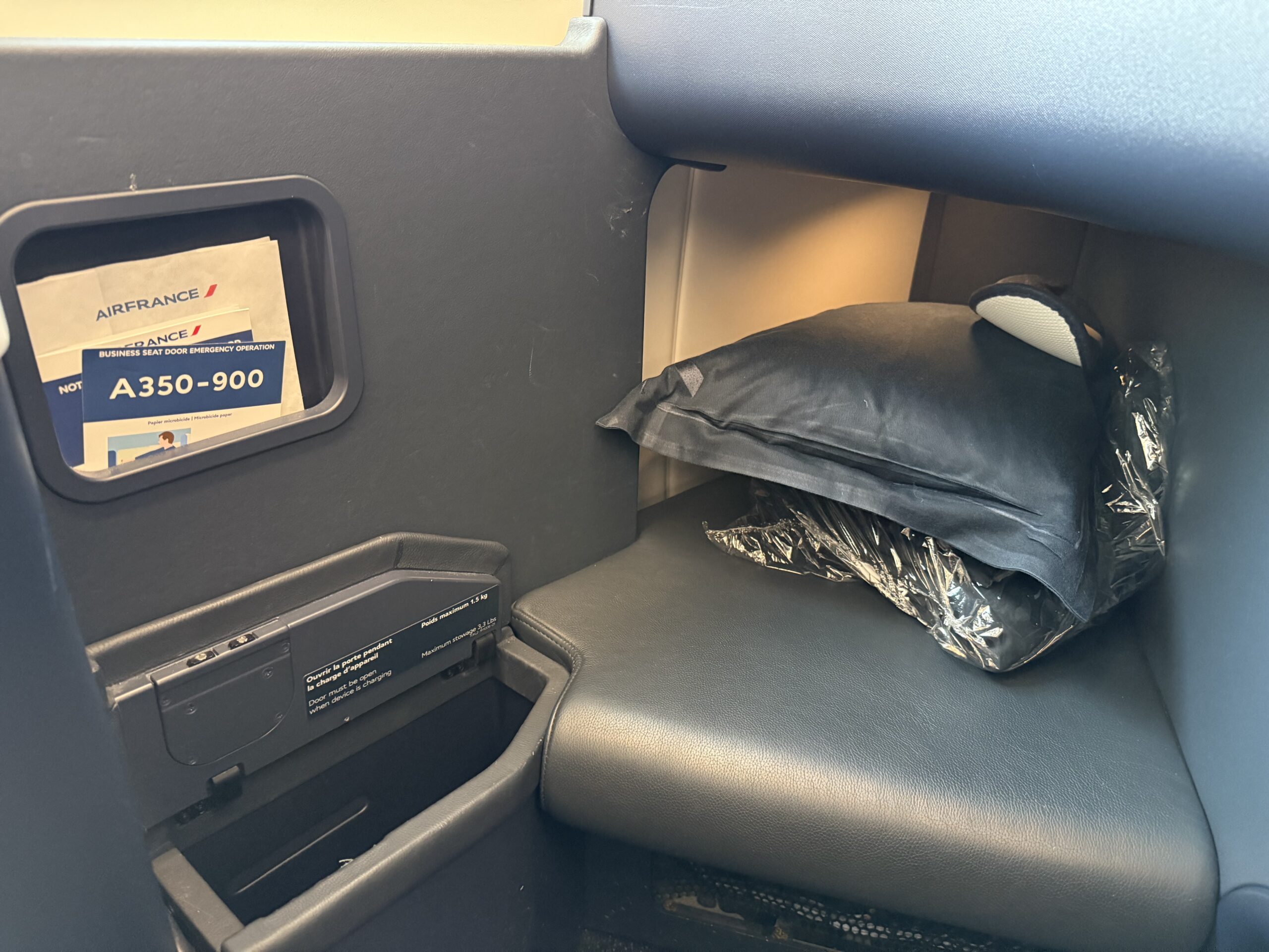 a seat with a black pillow and a black pillow in the middle