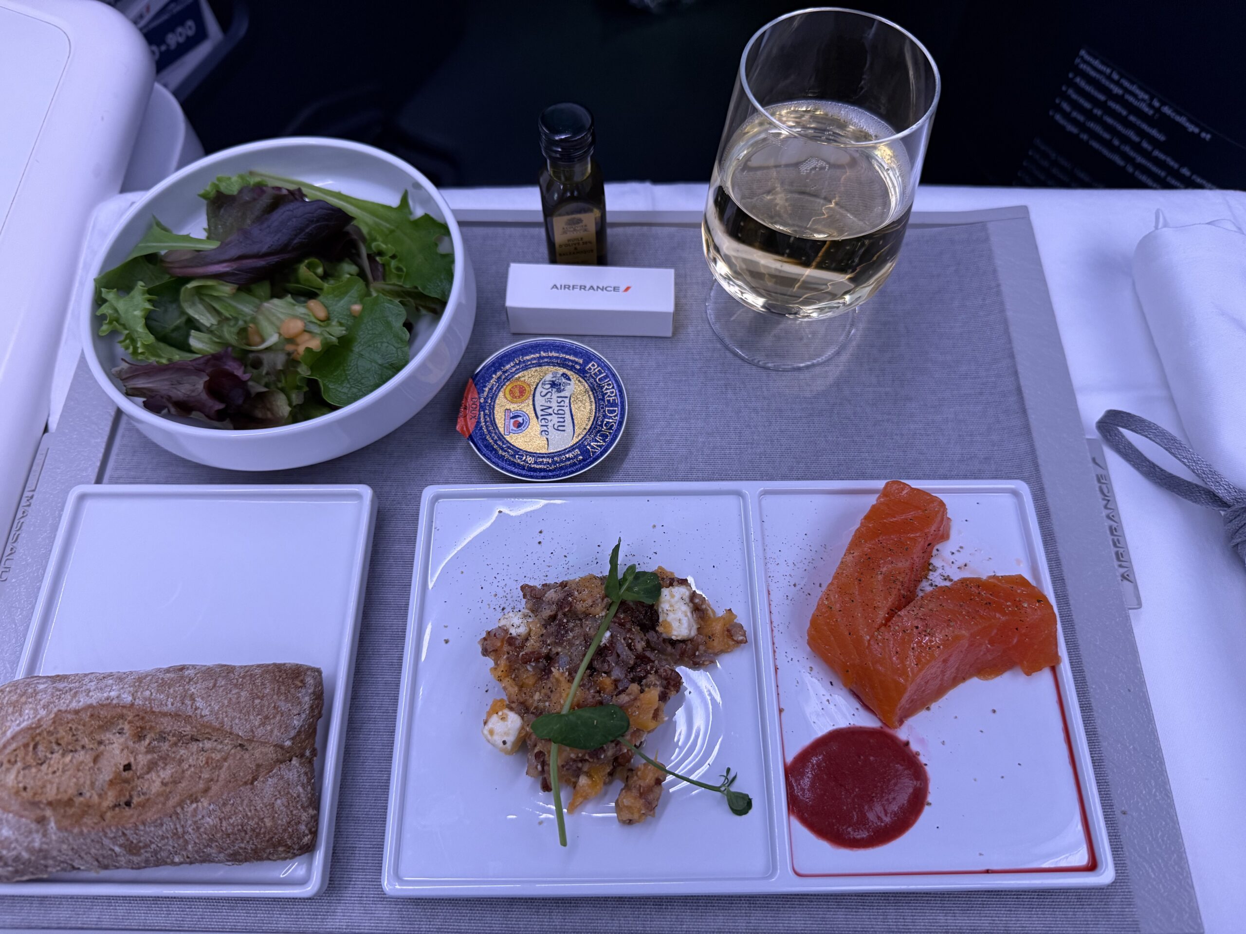 a plate of food and a glass of wine