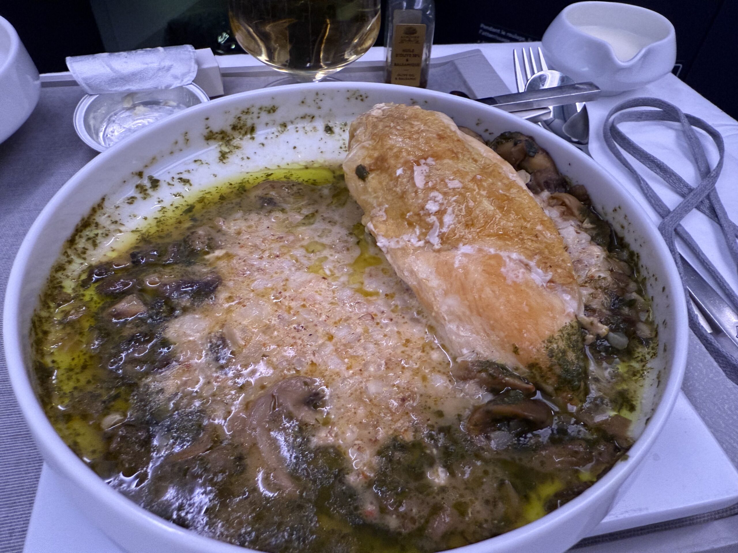 a bowl of soup with a piece of bread and a piece of bread in it