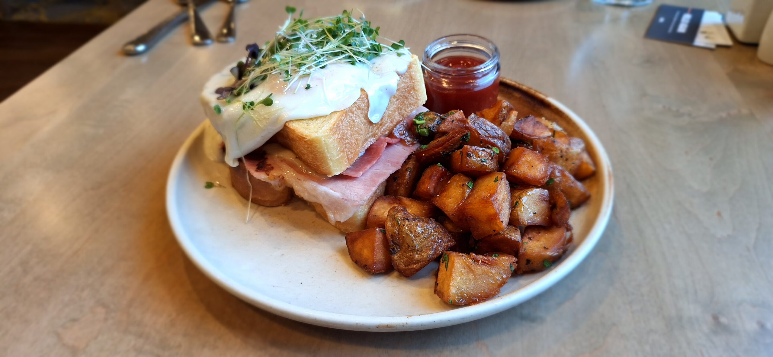 a plate of food with a sandwich and potatoes