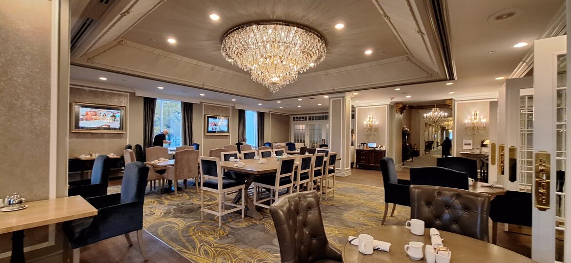 SK Hotel -Breakfast room 1 a room with a chandelier and tables