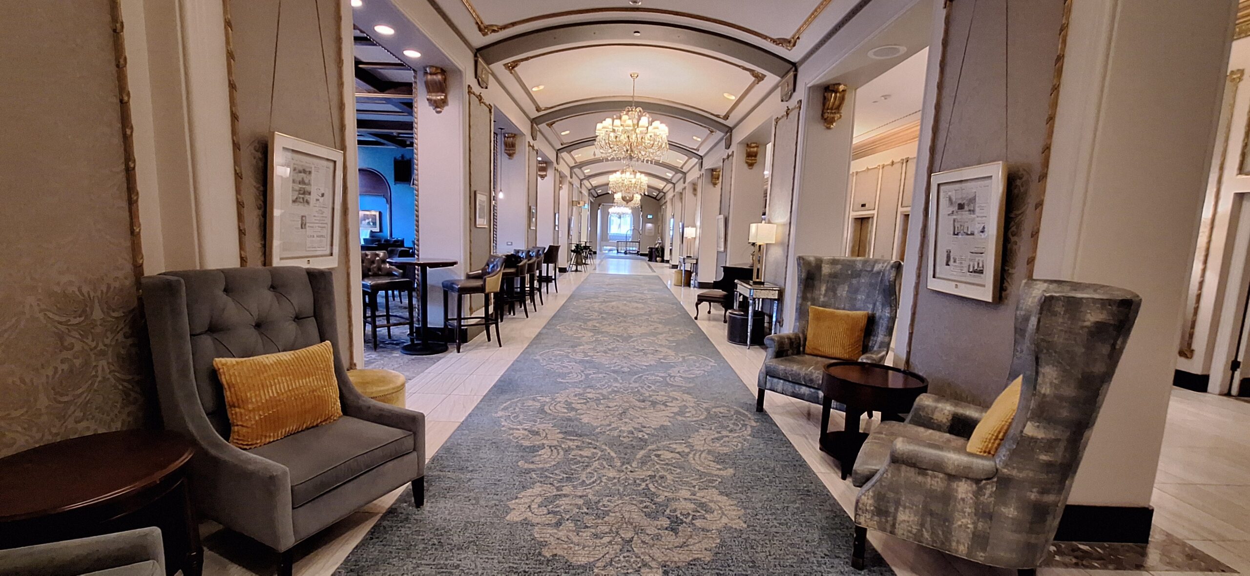 a long hallway with chairs and a rug