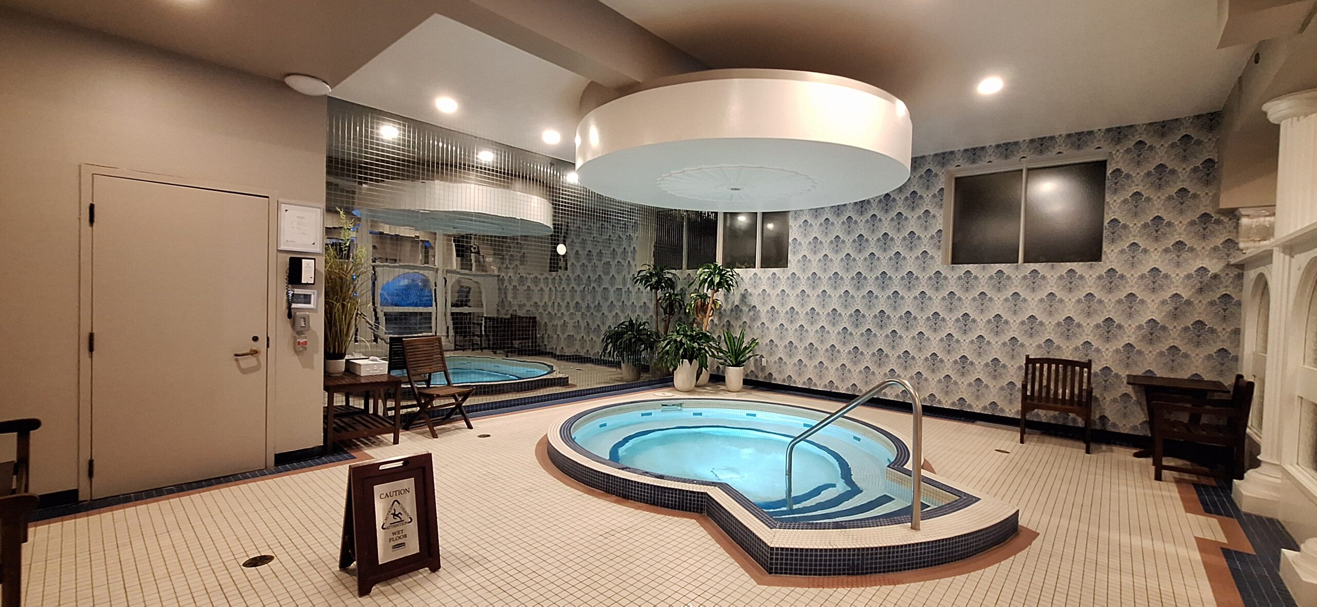 a indoor hot tub with a round pool
