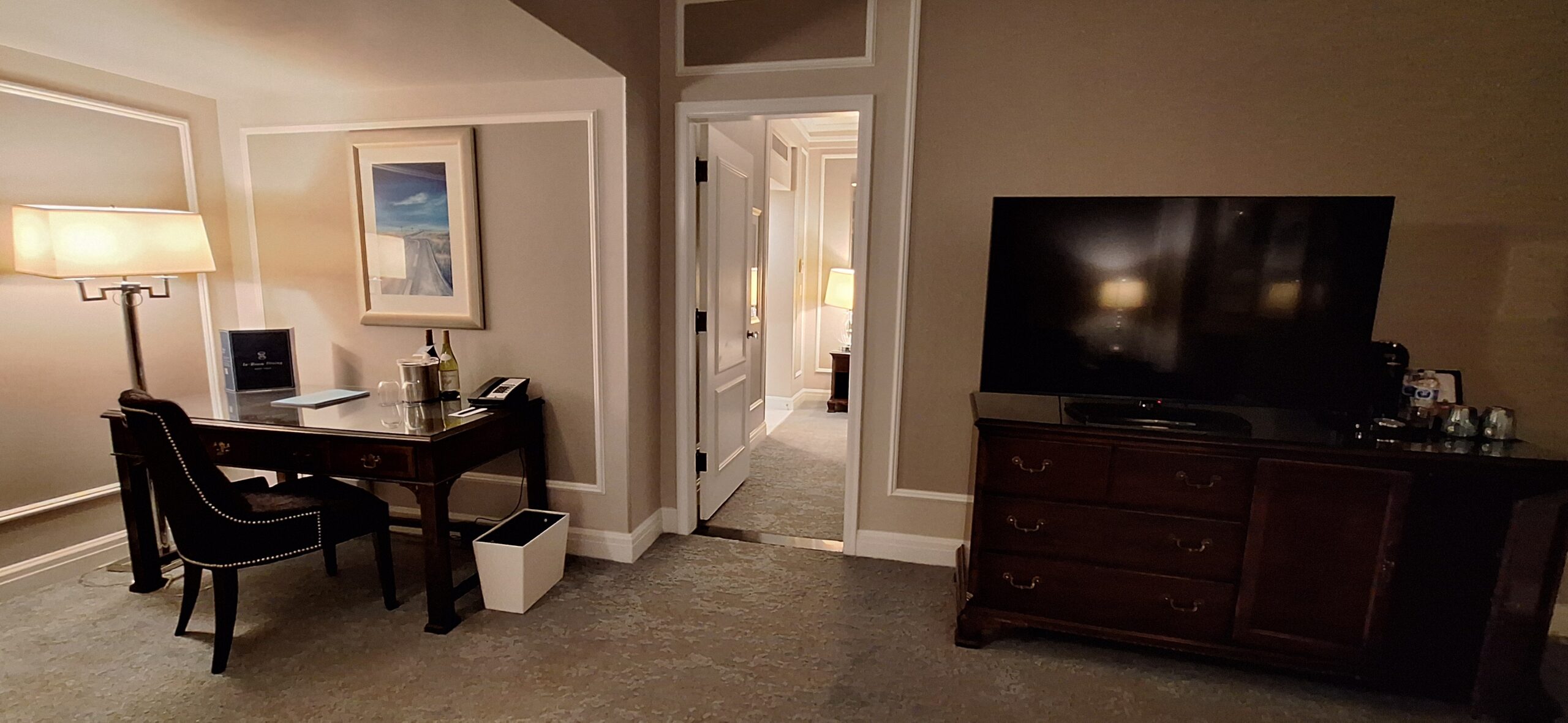 a room with a tv and a dresser