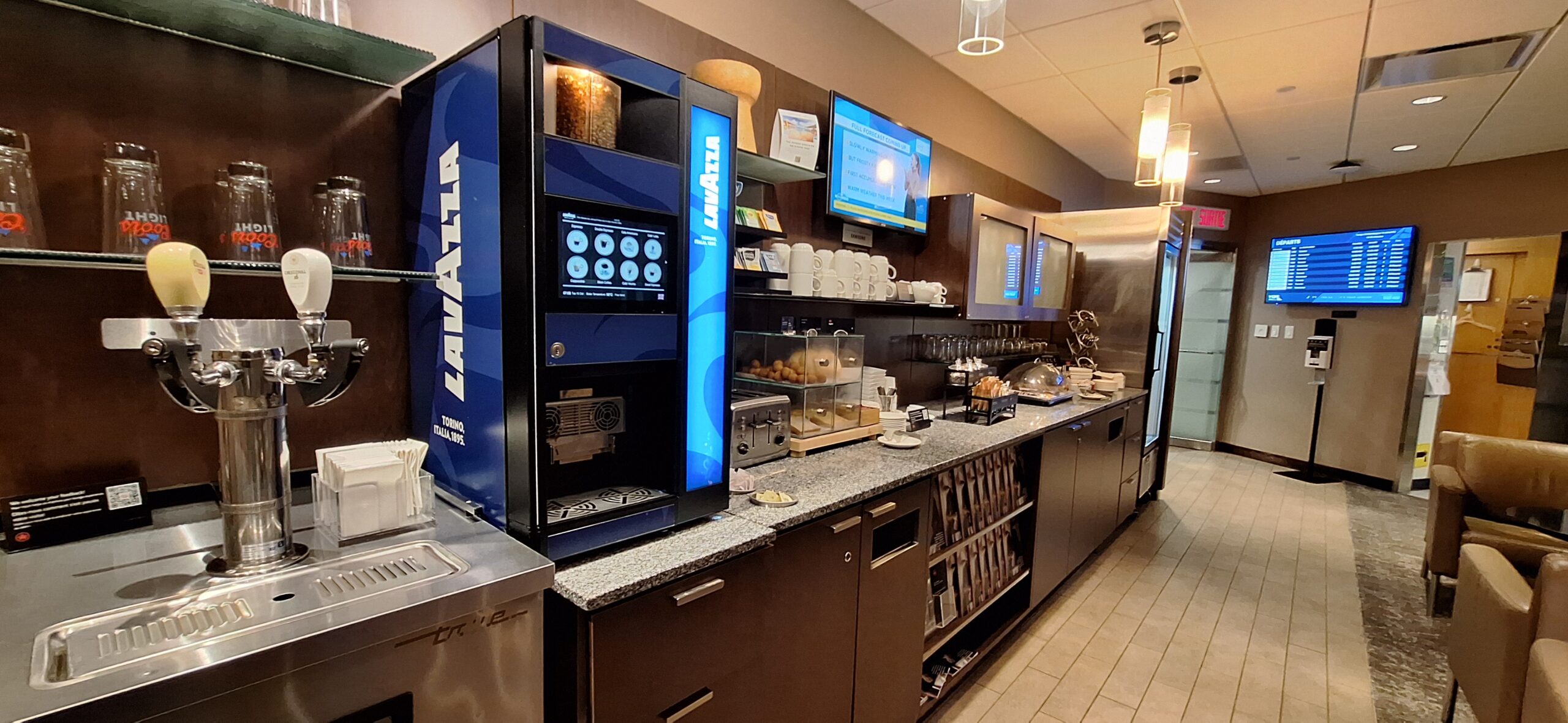 a kitchen with a counter and a large display