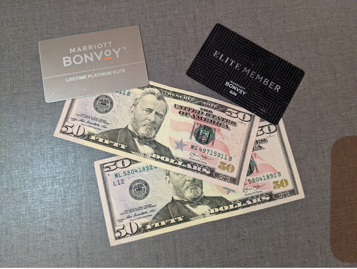 a credit card and money on a gray surface