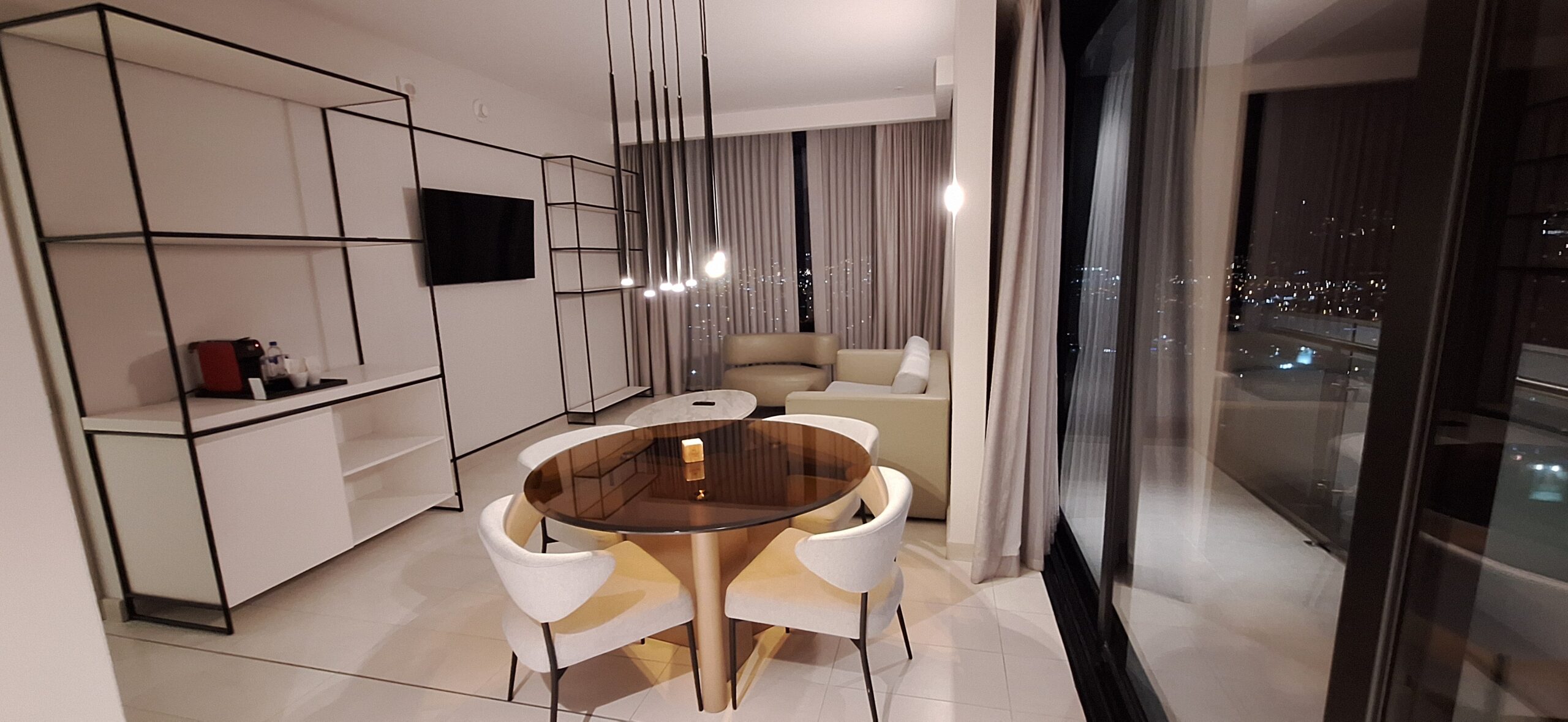 a room with a round table and chairs