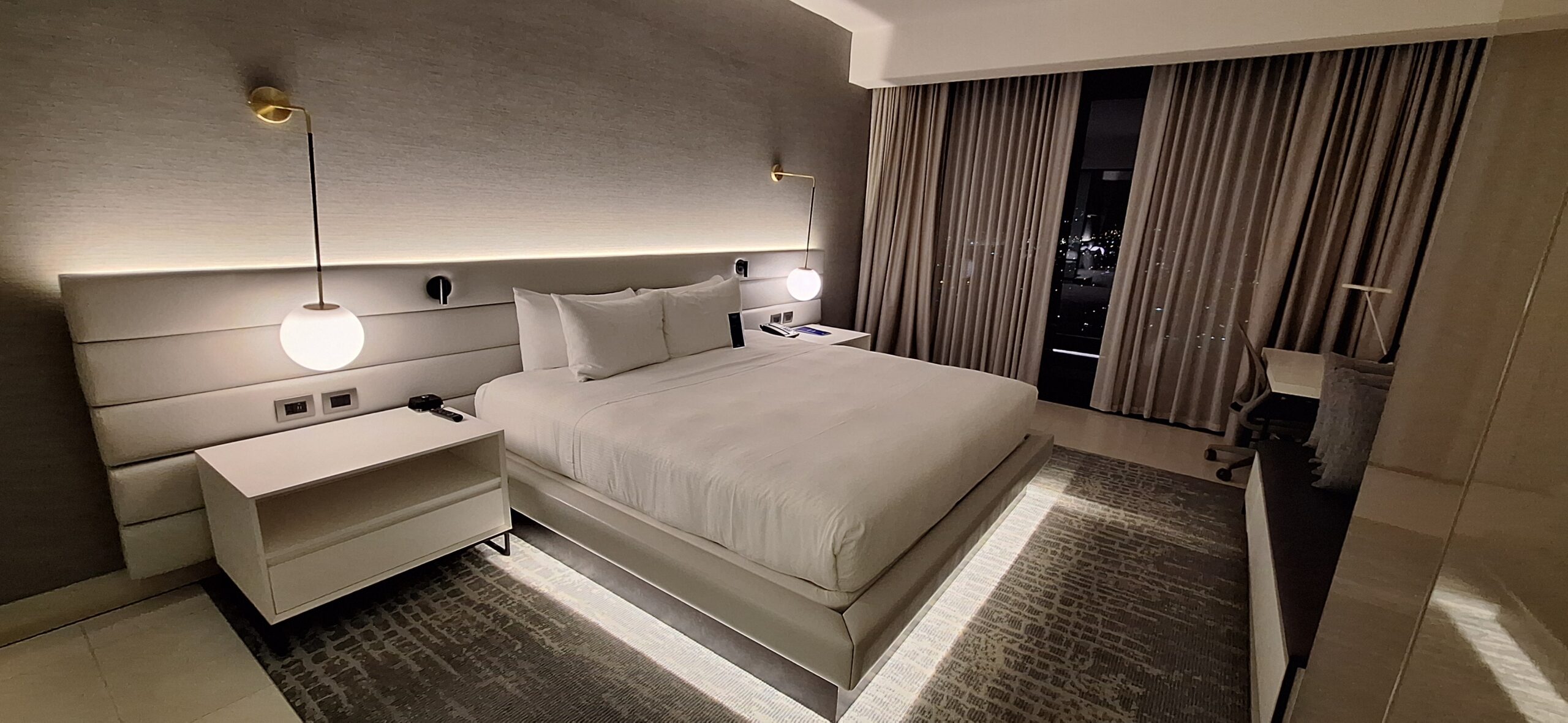 a bed with a light on the wall