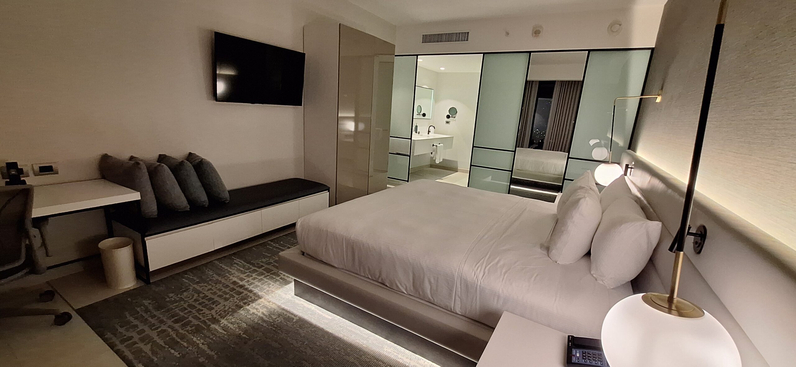 a bedroom with a bed and a mirror