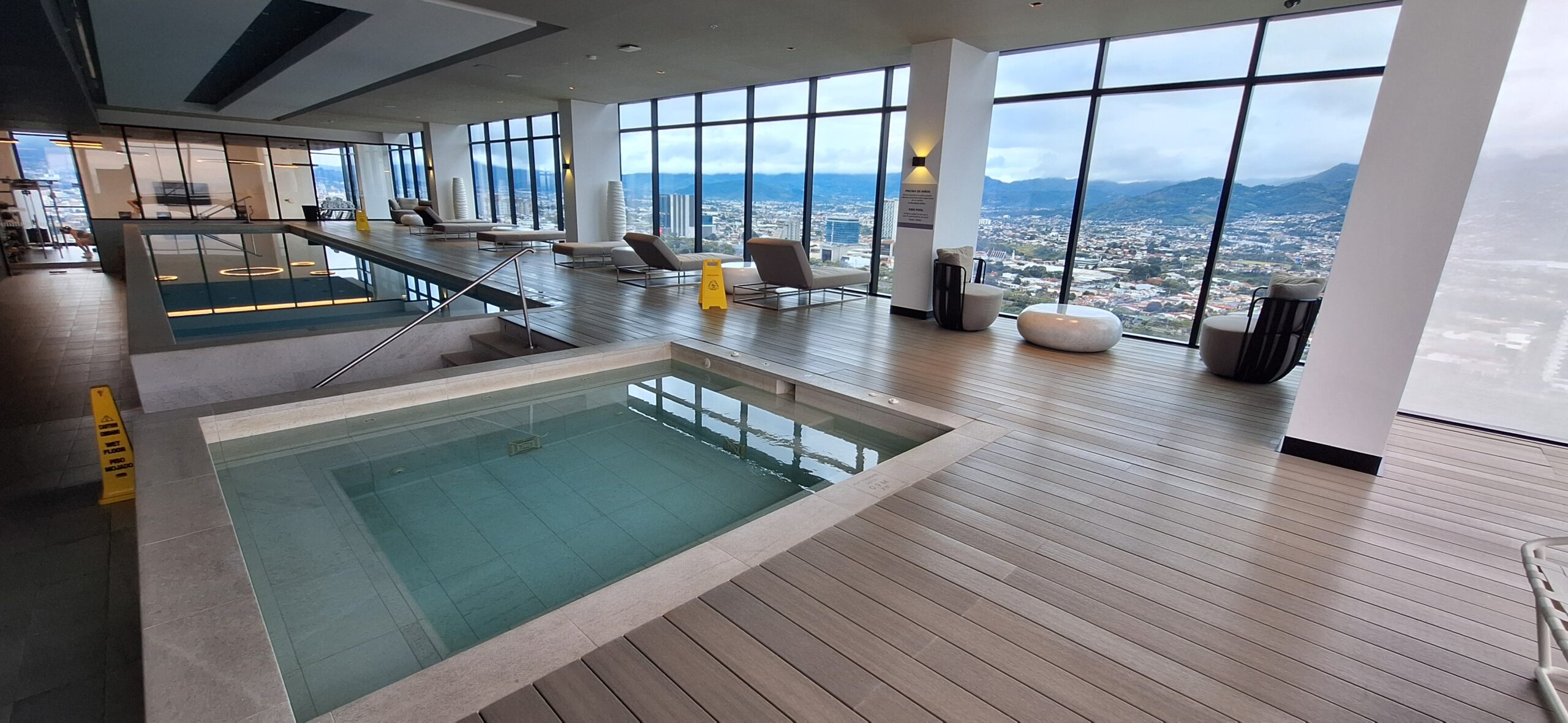 a large indoor pool with a view of a city