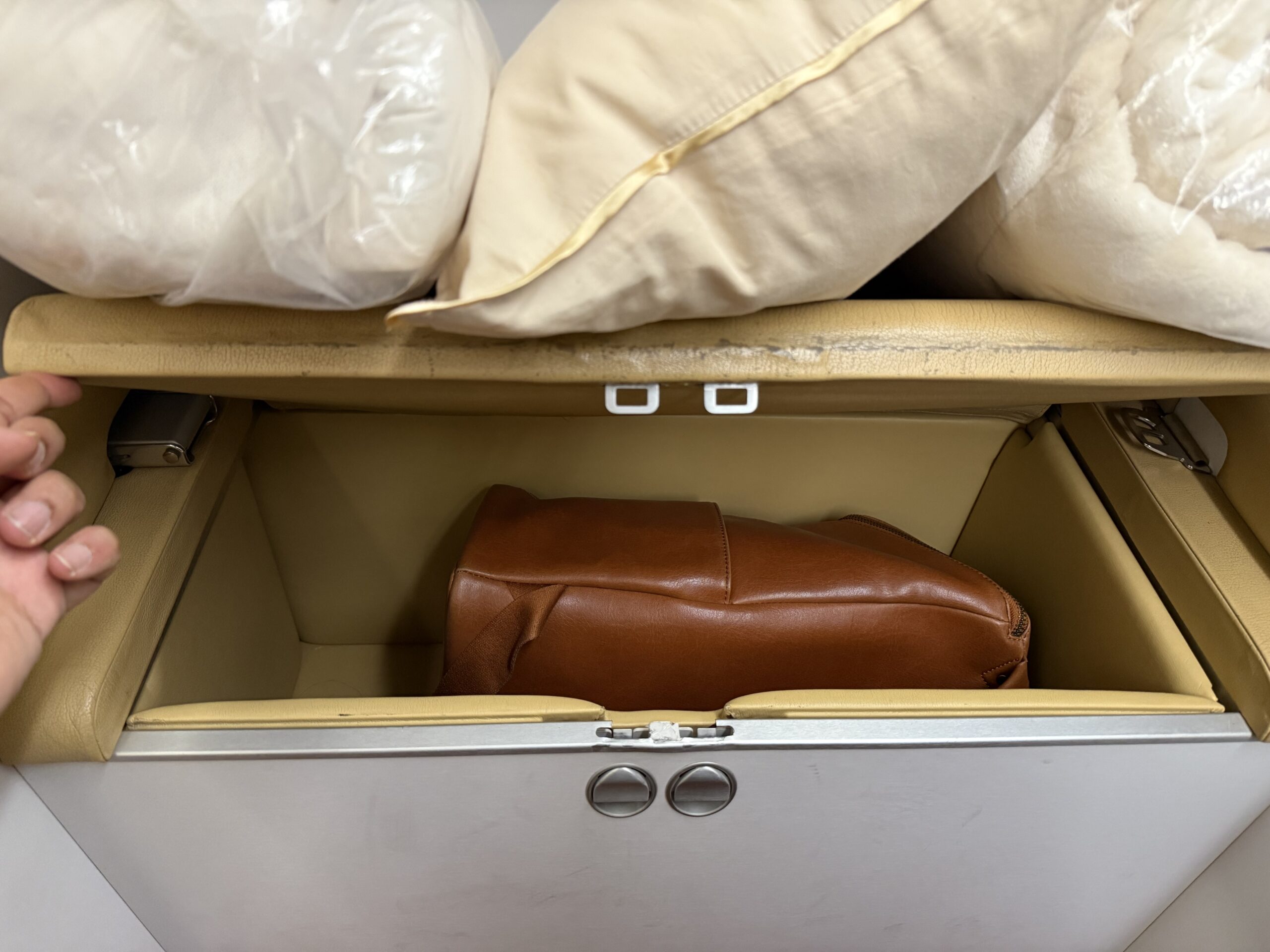 Air India First Class a brown leather bag inside of a suitcase