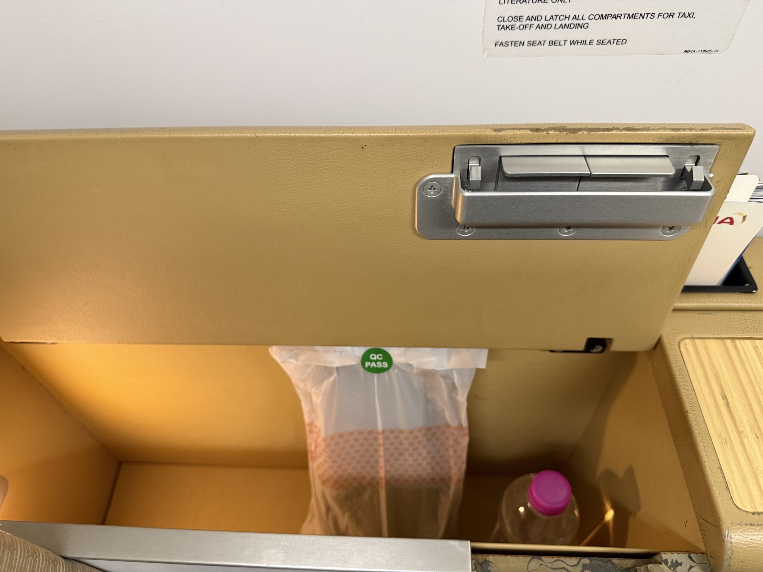 Air India First Class a drawer with a plastic bag inside