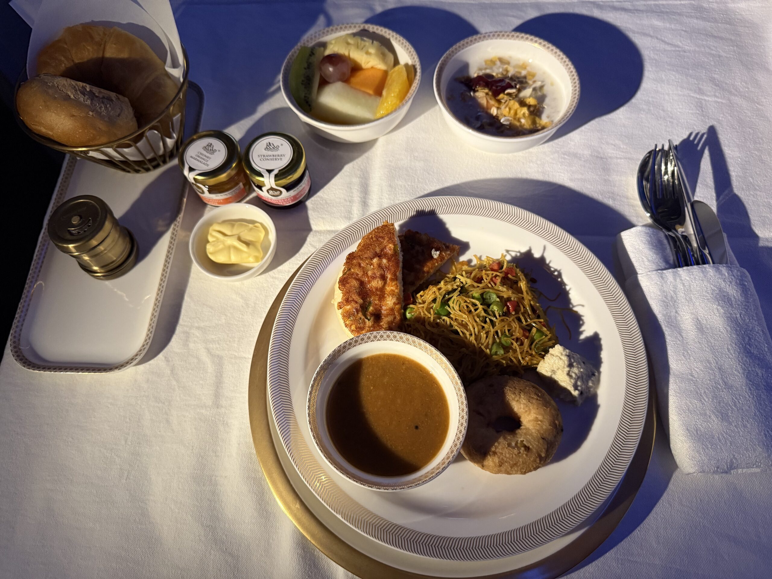 Air India First Class a plate of food on a table