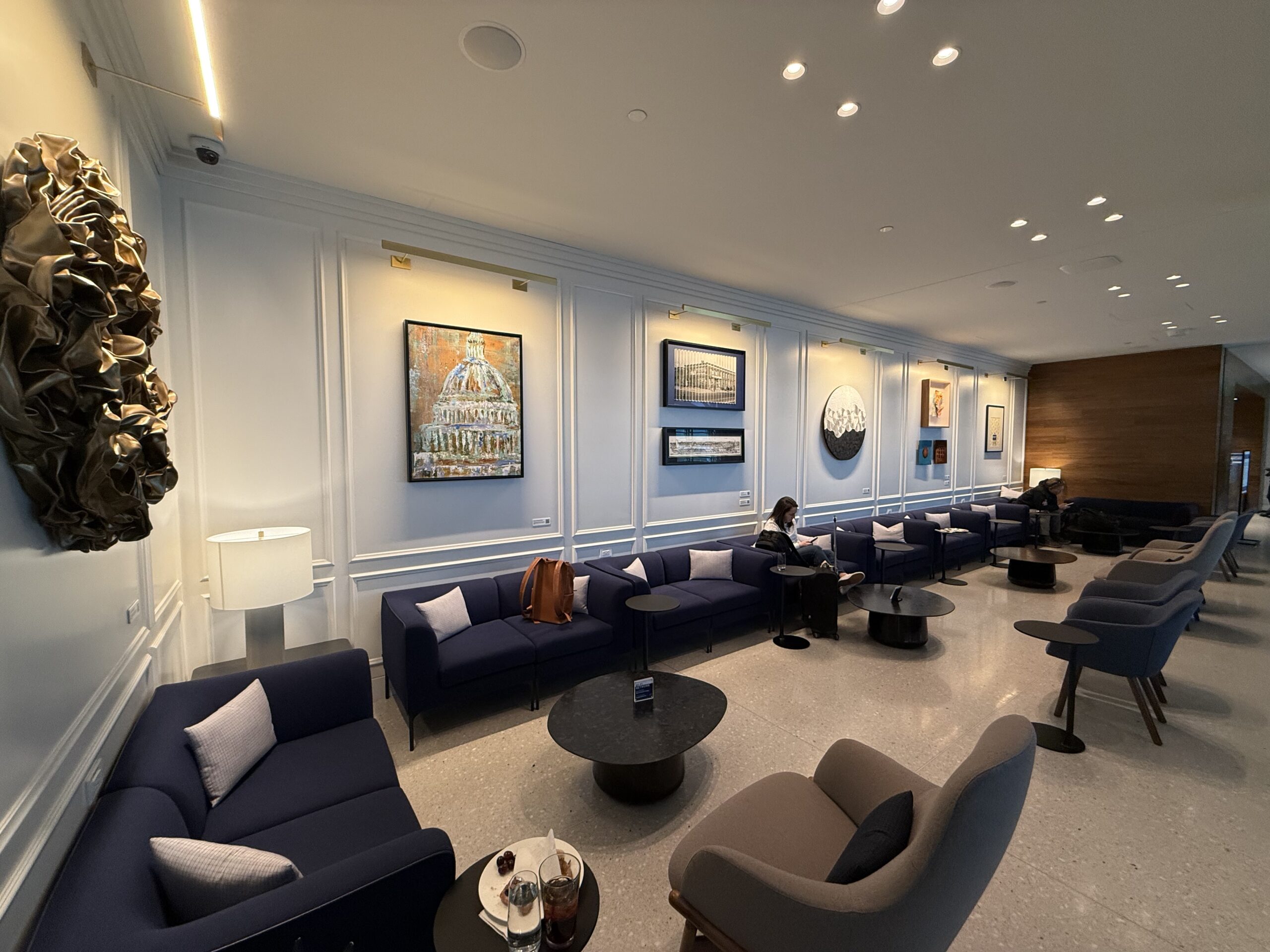 a room with a group of chairs and tables