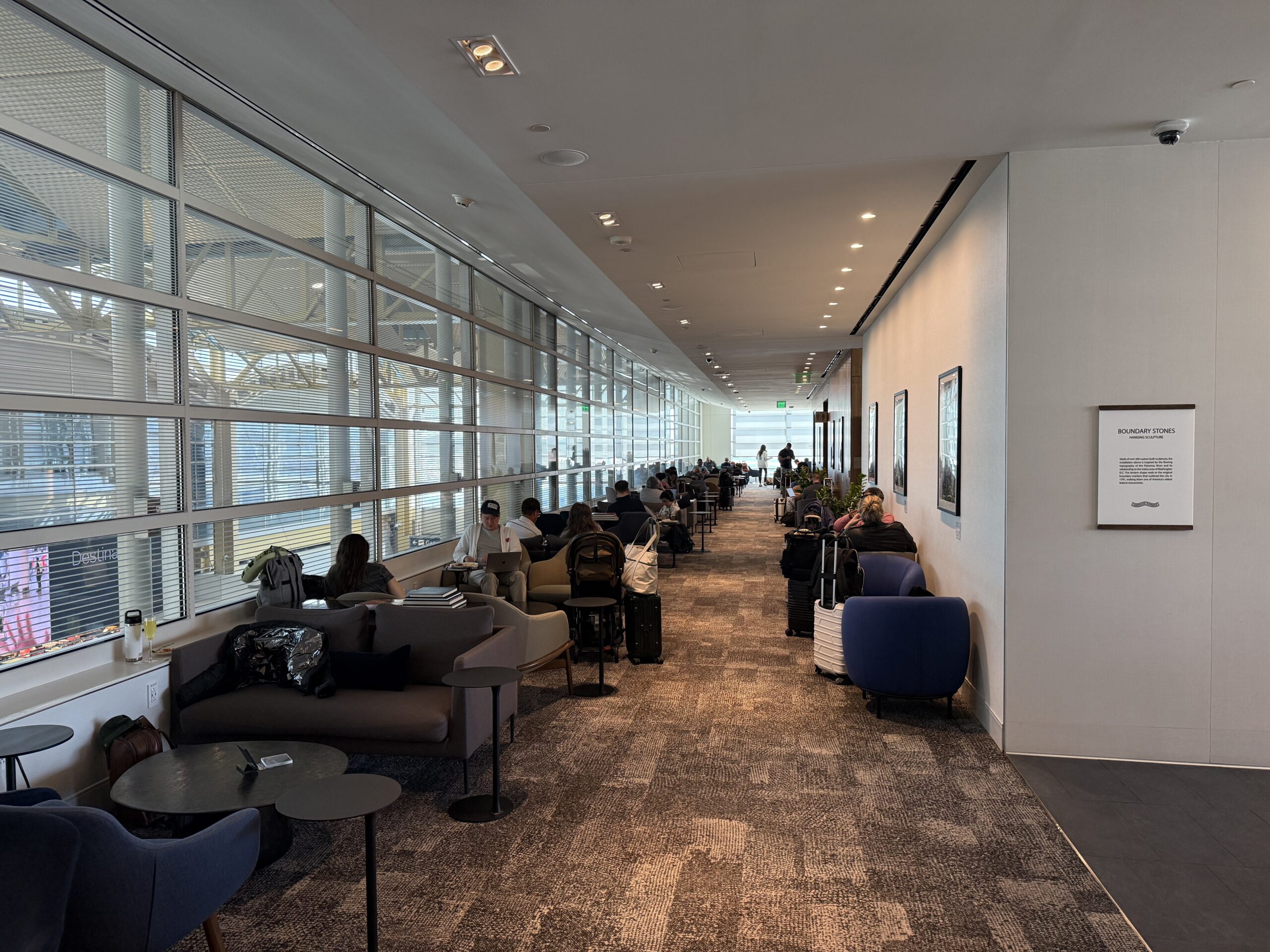 a long hallway with chairs and tables and chairs