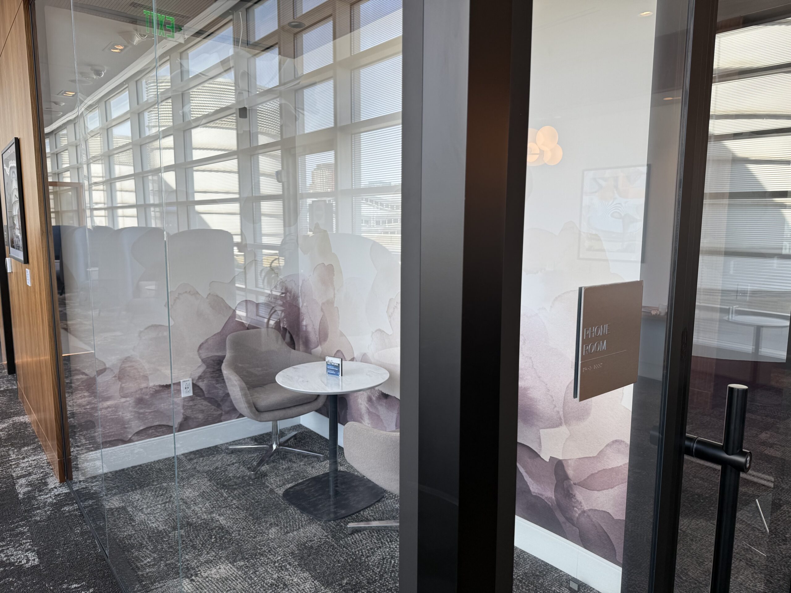 a glass wall with a table and chairs
