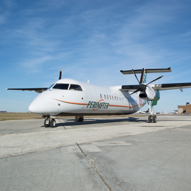 a white airplane on a runway