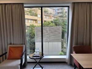 Sheraton Miyako Hotel Tokyo a room with a window and couches