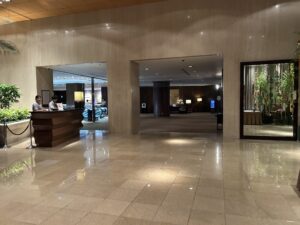 Sheraton Miyako Hotel Tokyo a lobby with a reception desk and a couple of people