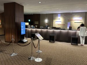 Sheraton Miyako Hotel Tokyo a man standing behind a counter